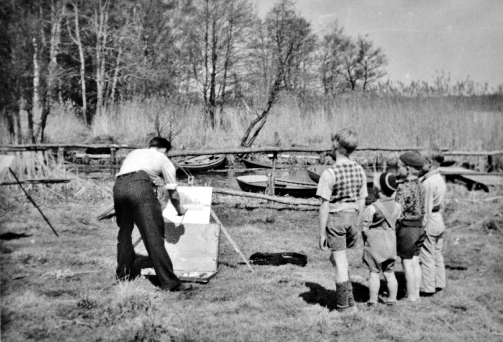 Pappa - Pappa med publik. Här kan man faktiskt se vilket motiv det är han målar. Jag har motivet med bland bilderna ovan.
